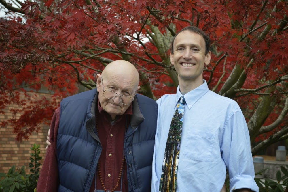  Michael Taylor stands with his son, biology professor David Taylor: Michael is a frequent visitor to campus, spending time befriending students, reading the newspaper or solving mathematical proofs.Photo by W.C. Lawson