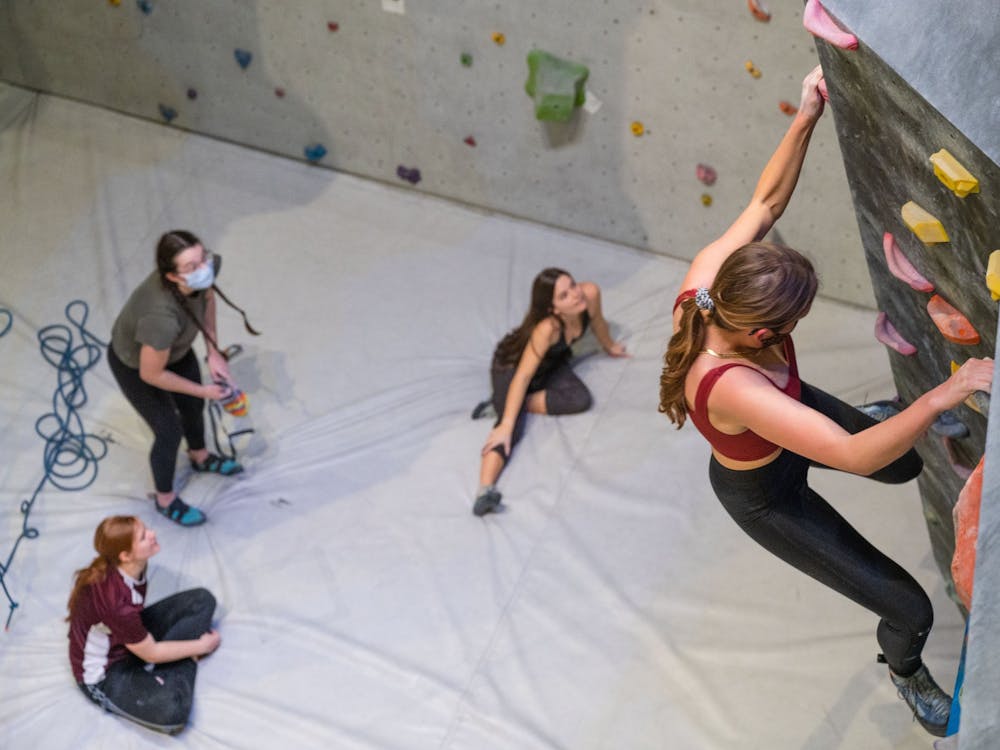 Climbers giving beta (climbing tips) for a bouldering route