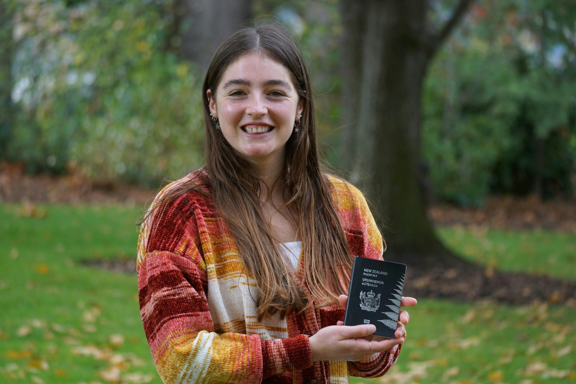 Grace Ritchie holding her New Zealand passport.