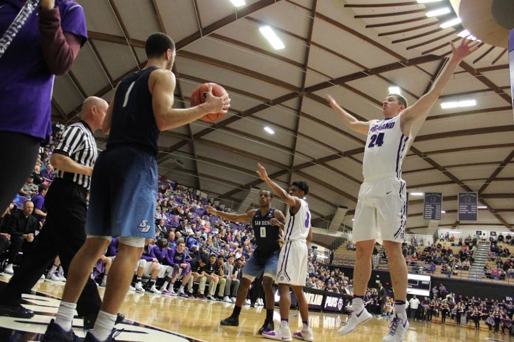 Gabe Taylor attempts to defend as the ball gets inbounded.