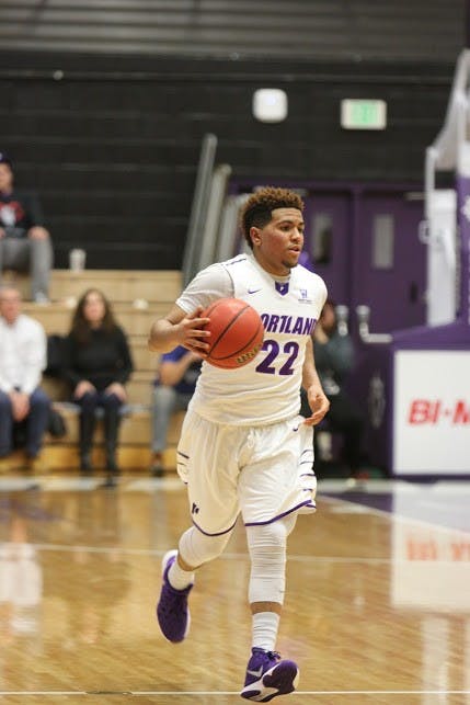 Photo by Hannah Baade | Jazz Johnson dribbles the ball down the court.