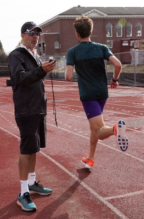  Photo courtesy of Kim Spir | Rob Connor times athlete during a cross country practice.