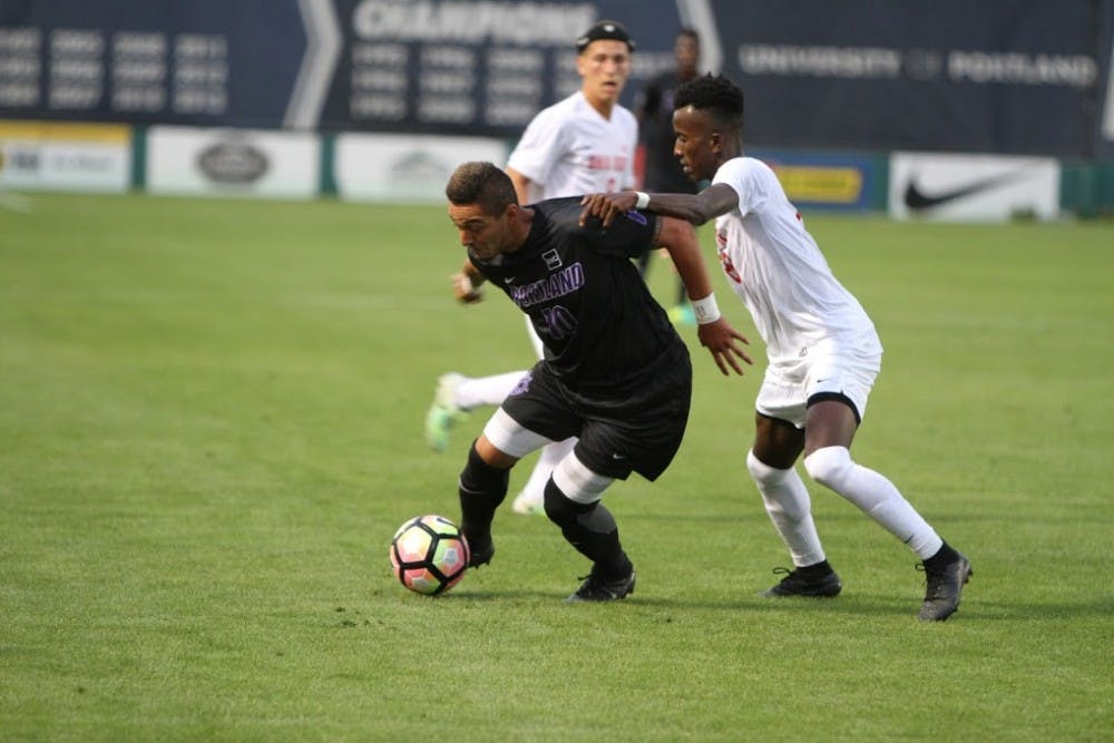 Senior midfielder Eddie Sanchez pushes through an Ohio State player's physical defense. 