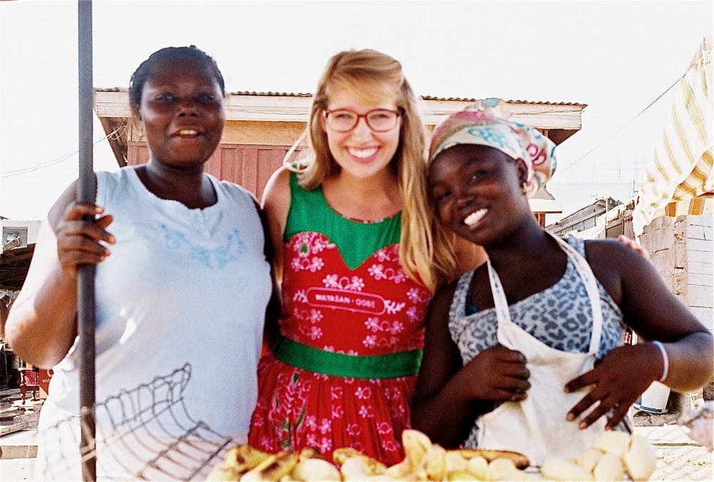  Senior Lindsey Morris with her friends Amma (left) and Afua (right), mother and daughter plantain sellers, in the town Ashaiman. Morris bought roasted plaintains and chatted with them nearly every morning on her way to work and passed by in the evening to wish them goodnight. Photo courtesy of Lindsey Morris