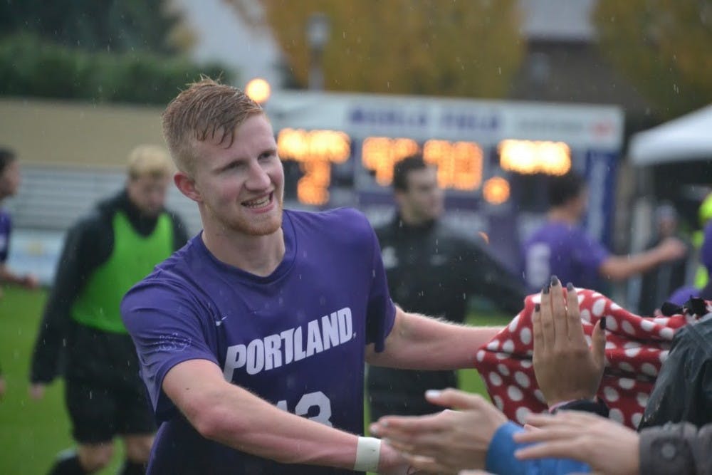  Senior Hugo Rhoades high fives fans after the Pilots 2-1 win over Pacific. The game served as "senior night" for Rhoades and teammate Colby Trah. | Photo by Thomas Dempsey