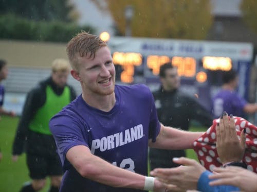  Senior Hugo Rhoades high fives fans after the Pilots 2-1 win over Pacific. The game served as "senior night" for Rhoades and teammate Colby Trah. | Photo by Thomas Dempsey