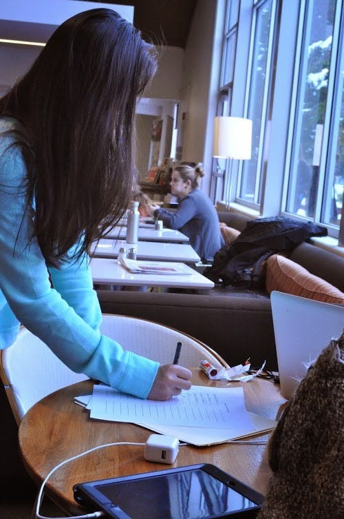  A student signs the petition asking administrators to reconsider the decision to deny biology professor Jeffrey Brown tenure.Photo by Kristen Garcia