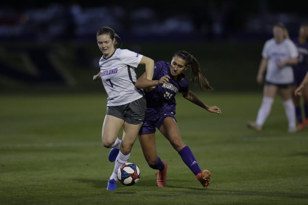 Senior defender Lucy Davidson fights for a ball. Photo courtesy of Stehpen Brashear.