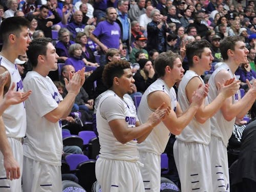  Photo by Kristen Garcia | The men's basketball bench applauds during game vs. BYU.