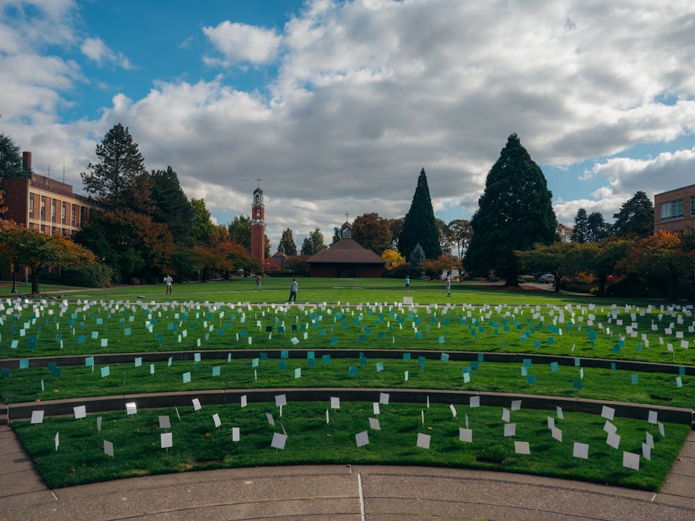 Academic quad showing blank papers in the lawn during last year's Fall Week of Action from SASA.