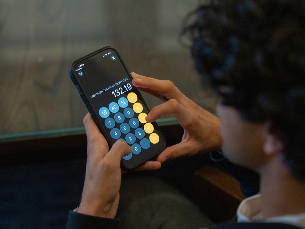 An FMB member calculates during a budget allocation meeting.