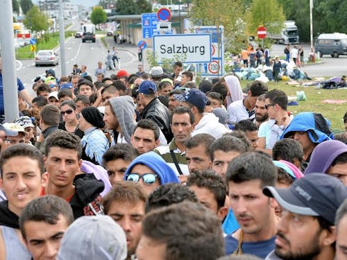  Refugees wait on a bridge after police stopped them at the border between Austria and Germany in Salzburg, Austria, Thursday, Sept. 17, 2015. (AP Photo/Kerstin Joensson)