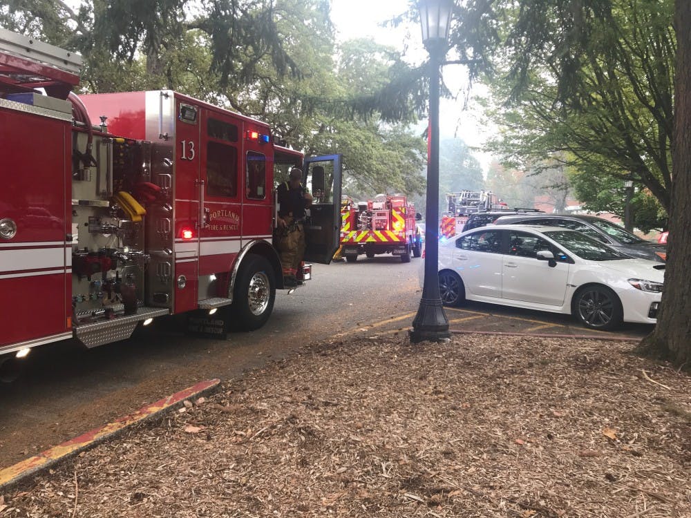 Firefighters arrive at Kenna Hall to put out a brush fire below campus. Adrienne Clark was charged with four counts of reckless burning in connection to the fires.