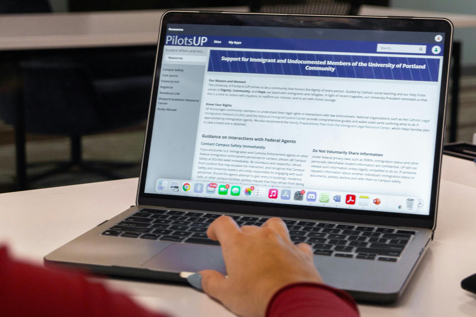 A student visits the “Support for Immigrant and Undocumented Members of the University of Portland Community” website.