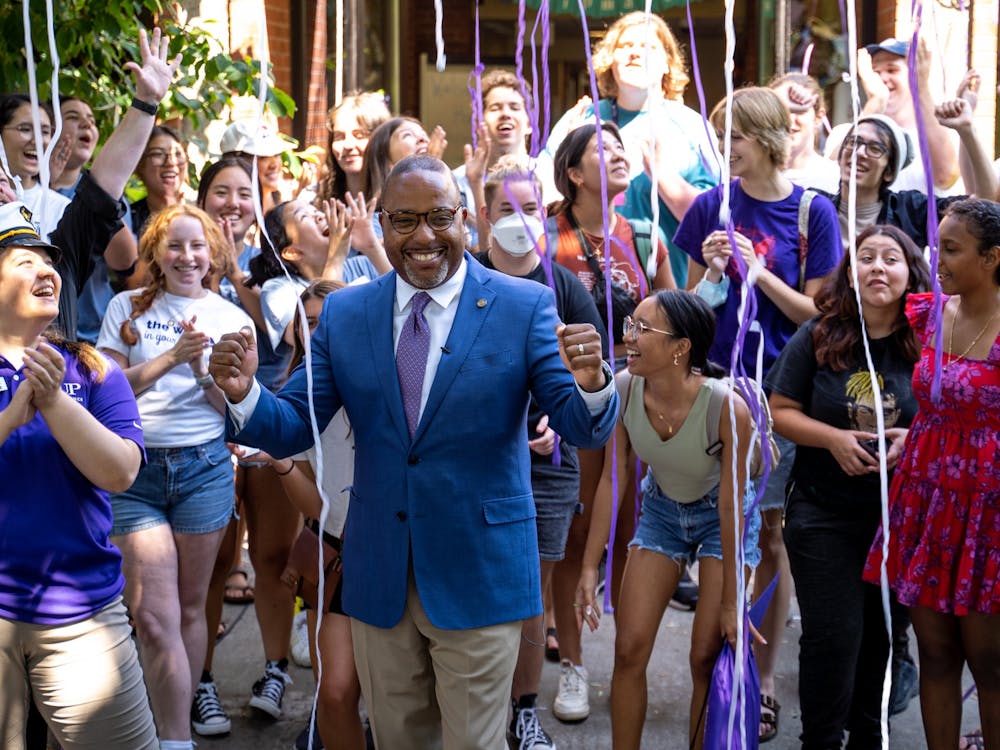 Dr. Robert Kelly, president of the University of Portland, cheers in front of Shipstad as a confetti cannon is fired. Move-in day for students in dorms was Thursday, August 25.