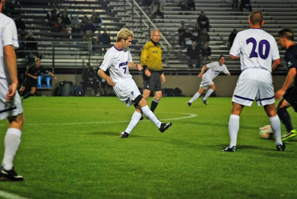  Freshman midfielder Matthew Coffey passes the ball to a teammate in what became a very physical match Wednesday.Photo by Parker Shoaff