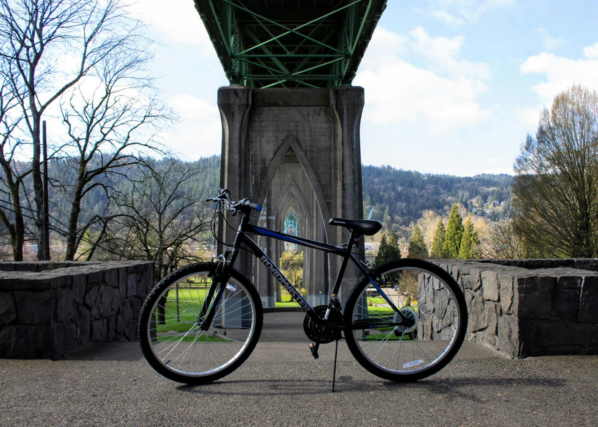 A bike sits below St. Johns Bridge at the entrance to Cathedral Park. Biking is a great way to get across town while staying active.