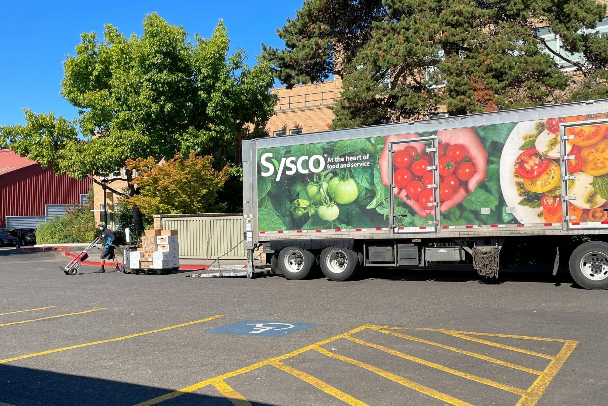 A worker delivers food supplies to the Commons.
