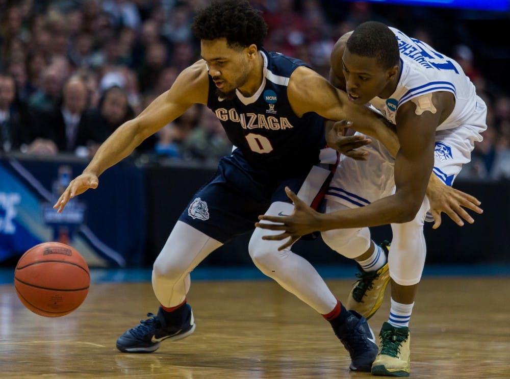  Silas Melson goes for the ball against a Seton Hall player. Gonzaga went on to beat Seton Hall in the first round of the NCAA tournament. Photo by Edward Bell courtesy of the Gonzaga Bulletin