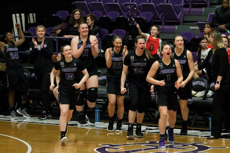 An ecstatic Portland bench rushes the court after the final whistle to congratulate their teammates on their last victory of the season.