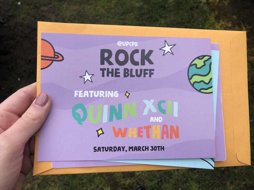 CPB announced the Rock the Bluff artists by handing out envelopes to students after Dance of the Decades. 