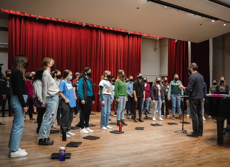 Director Dr. David DeLysser conducts students during a choir rehearsal. UP Choir students rehearse for their upcoming concert performances this week.