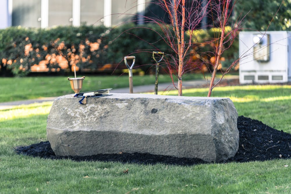A stone bench and a Japanese Maple tree outside Christie Hall commemorate the life of Owen Klinger. 