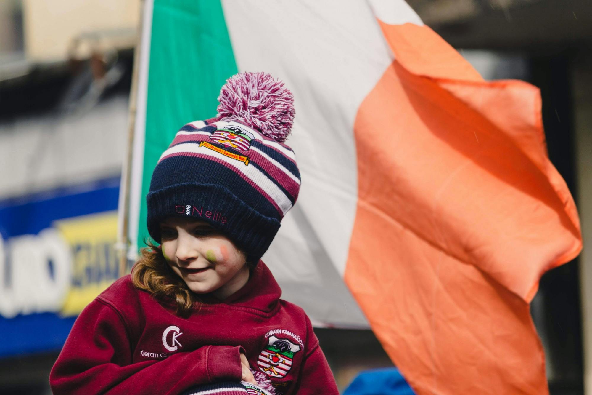 A young girl smiles at the parade spectators while her camogie team walks through Galway city center in 2019. Submission courtesy of Molly Lowney.