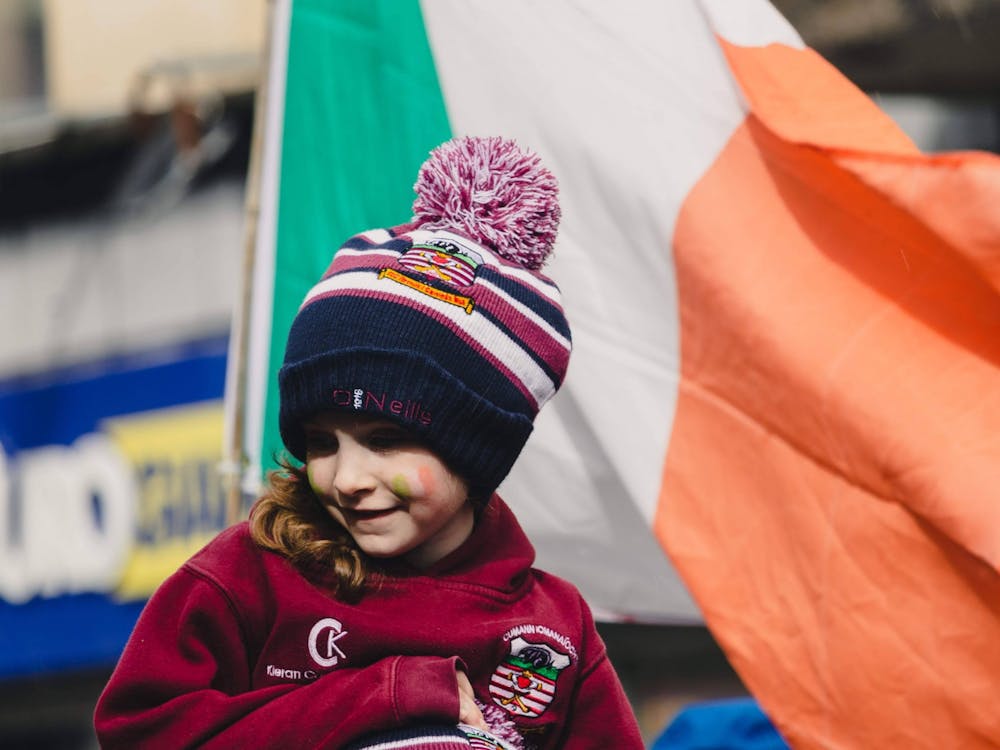 A young girl smiles at the parade spectators while her camogie team walks through Galway city center in 2019. Submission courtesy of Molly Lowney.