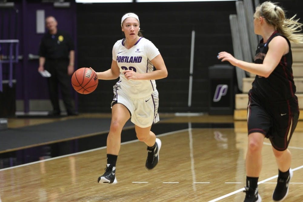  Photo by Hannah Baade | Freshman Darian Slaga dribbles the ball down the ball down the court. Slaga finished the night with six points and a block.