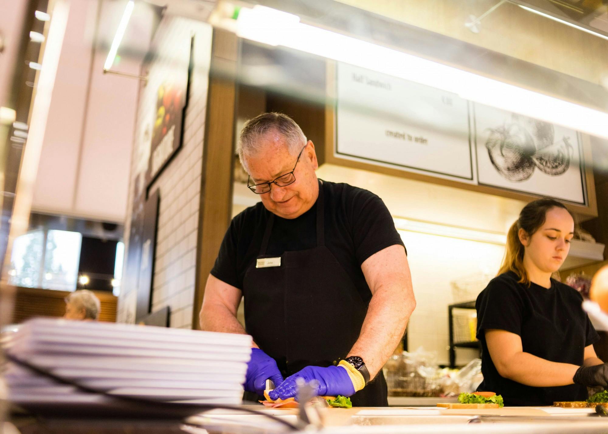 John Goldrick slices a sandwich during lunch hour at the Bauccio Commons. Years prior, Goldrick served as the university's vice president for 14 years. 