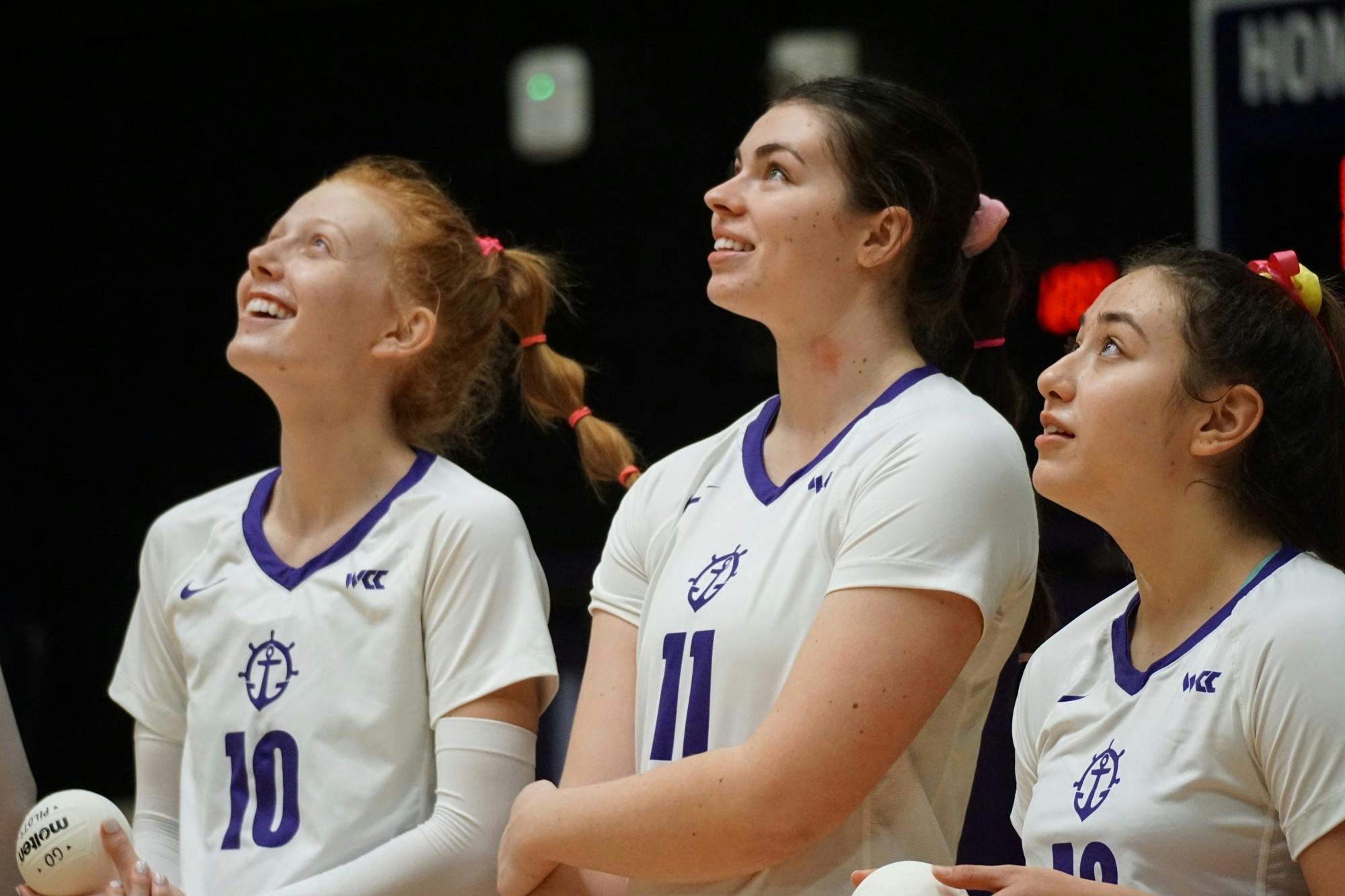 Emma Swett (left), Chelsey Harmon (middle), and Keilani Mumolo watch the big screen during the Pilots' introduction.