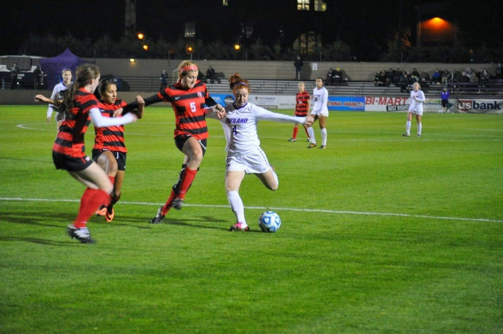  Junior Emily Sippel strikes the ball past three Seattle U defenders.Photo by David DiLoreto/The Beacon