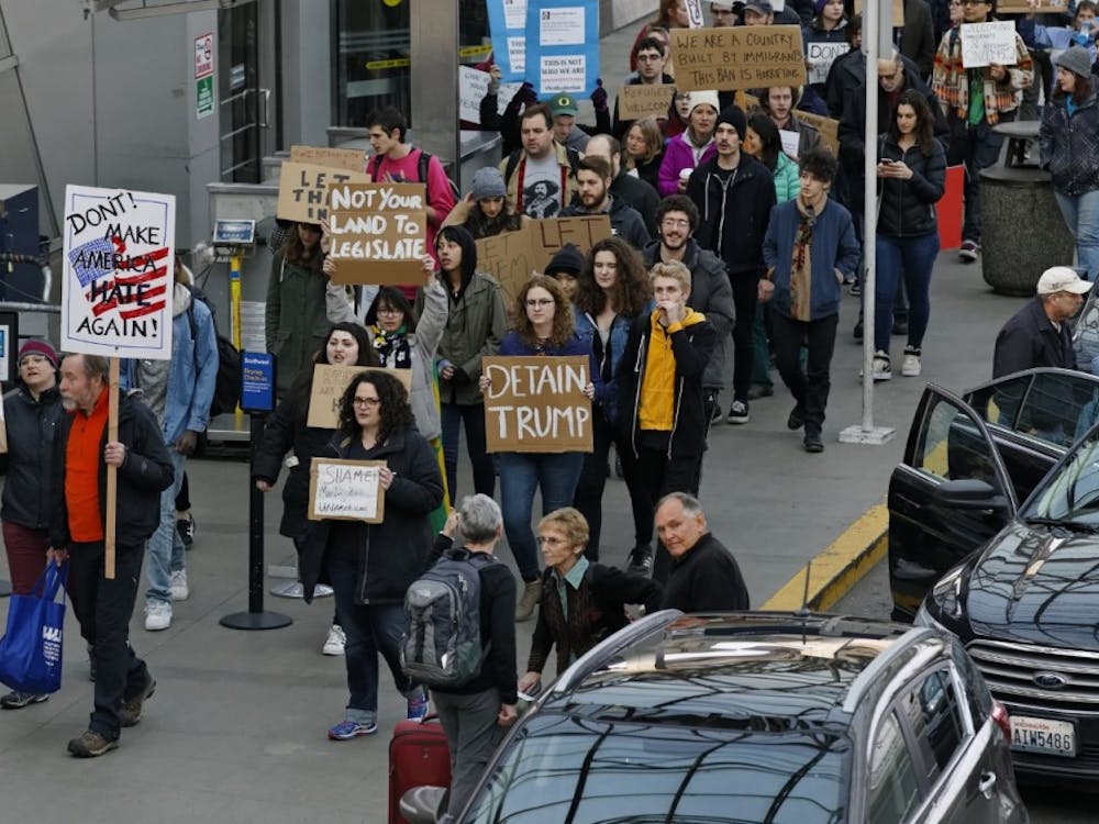 Dozens of demonstrators marched in and around the main terminal at Portland International Airport, to protest President Donald Trump's order restricting immigration into the U.S. Saturday. The protests continue. (Mike Zacchino/The Oregonian via AP)