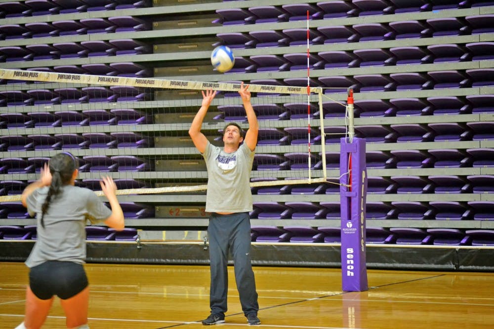  New volleyball head coach, Brent Crouch, fit right in with the team this week as he demonstrates a play for the setters during practice.Photo by Katie Dunn