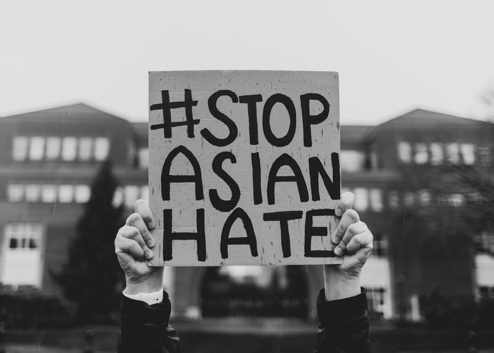 A student holds a sign with the trending hashtag #stopasianhate in UP&#x27;s main academic quad. The Beacon spoke with four Asian American UP students about their reflections on the recent increase in hate crimes against the Asian American community. Photo Illustration by Molly Lowney and Jennifer Ng