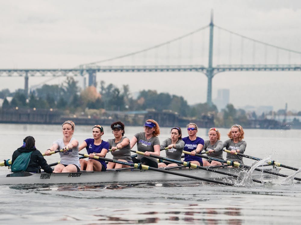 The Pilot rowing team paddles past the St. Johns bridge during a practice on the Willamette.