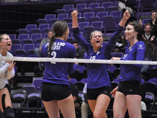  Photo by Kristen Garcia | Pilots celebrate after winning a point. The team went on to sweep No. 23 USD.