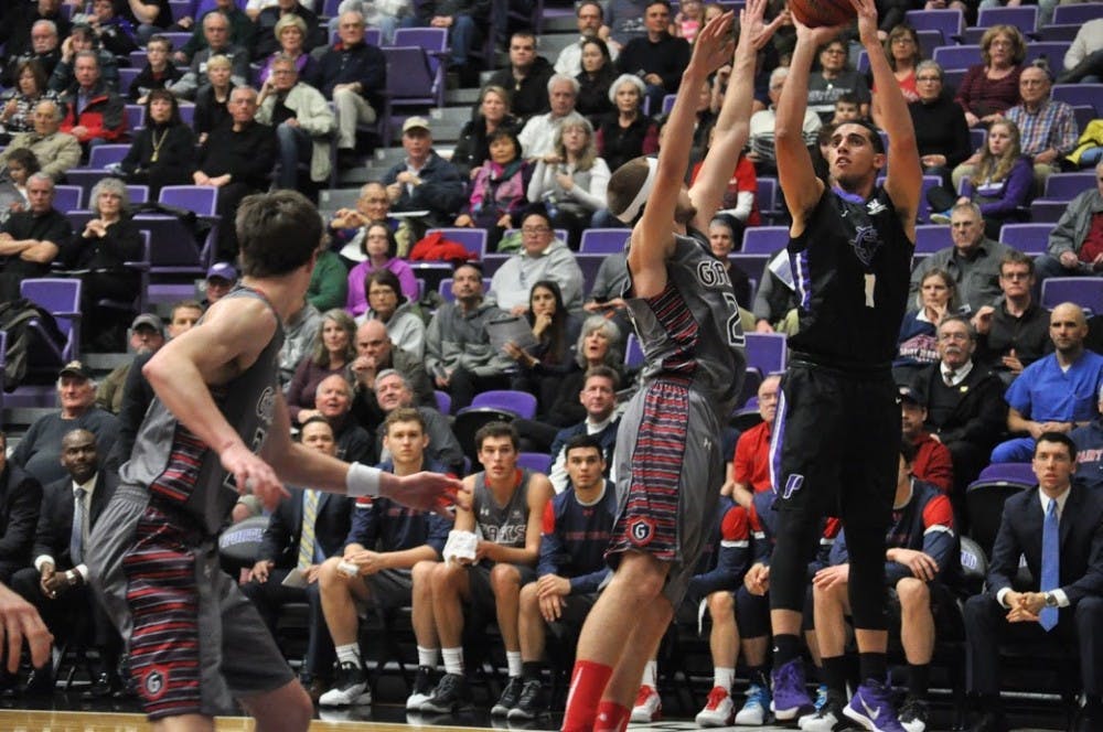  Bryce Pressley goes up for a 3-point shot over a St. Mary's defender. Pressley recorded a game high 25-points to become the 39th player in Pilot history to record 1,000 career points.