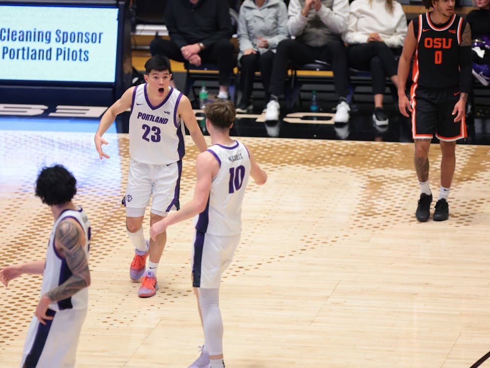 Freshman guard Joel Foxwell celebrates with junior guard Garrett Nuckolls in a win against Oregon State. Photo courtesy of Portland Pilots Digital Media.