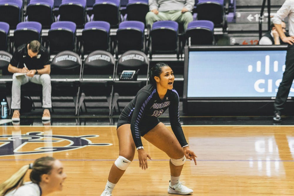 Junior Carey Williams calls out to her team before setting the ball for her teammate.