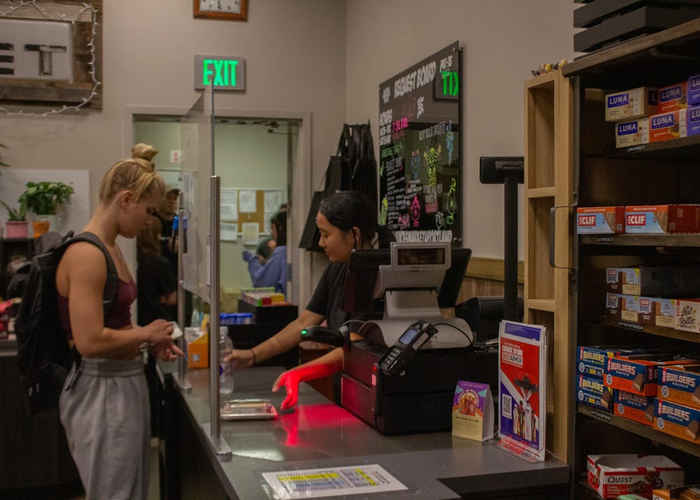 A student checks out at Macks Market located in the Pilot House. Being a cashier at Macks is one of many student jobs here on campus.
