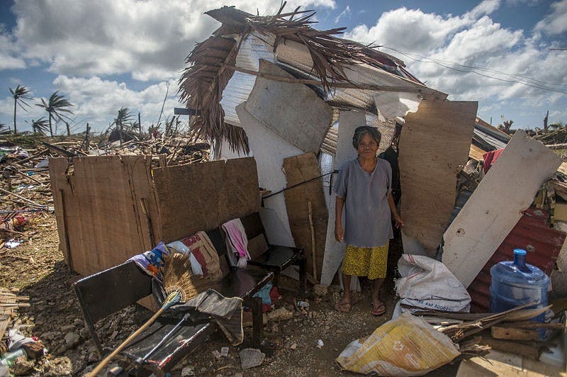  A Guiuan woman stands outside of her makeshift shack in the aftermath of Super Typhoon Haiyan.Photo courtesy of Wikimedia Commons