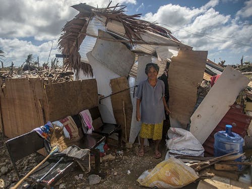  A Guiuan woman stands outside of her makeshift shack in the aftermath of Super Typhoon Haiyan.Photo courtesy of Wikimedia Commons