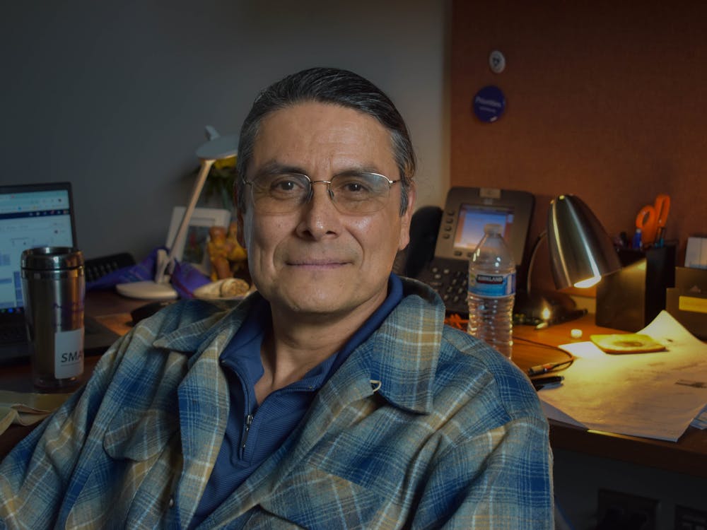 Philosophy professor Alejandro Santana sits in his office inside of Dundon-Berchtold Hall.