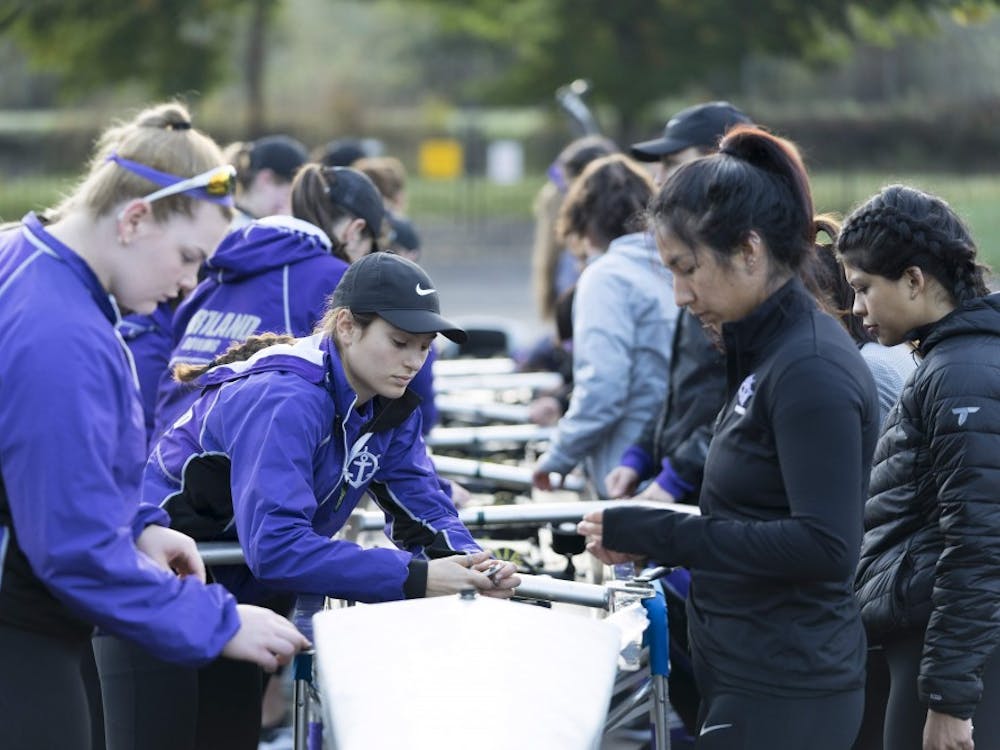 Senior captain Jacquelyn Bass helps prepare a boat before rowing practice.