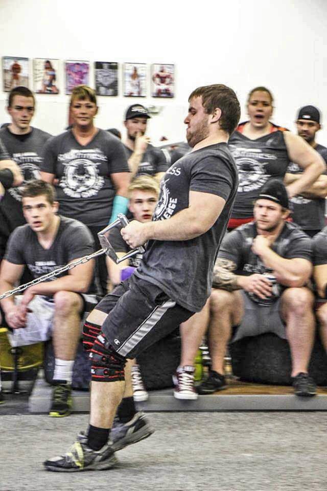  Freshman Parker Schibel pulls weights during an event at a strongman competition. Photo courtesy of Blaise Szallasi