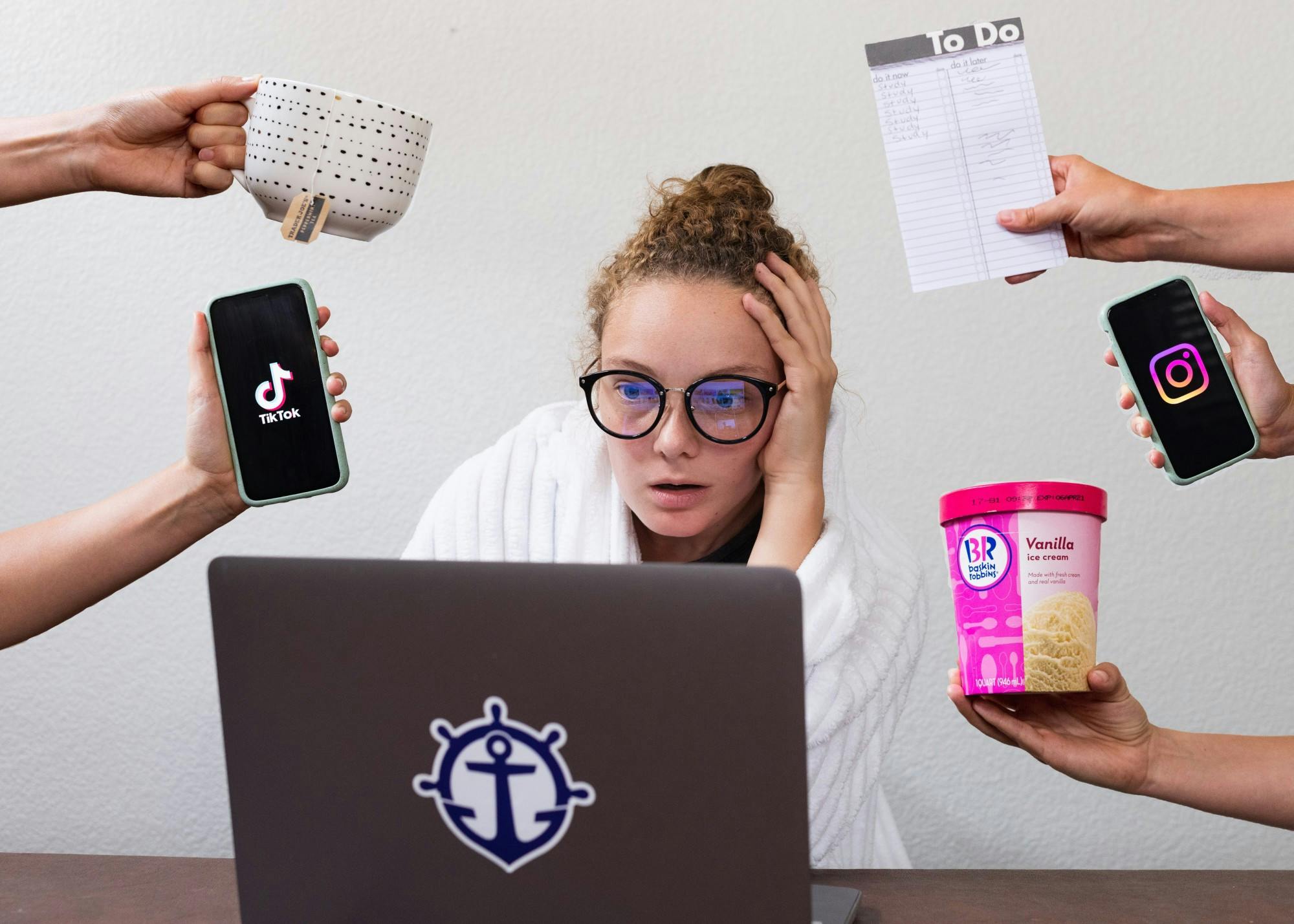 A UP student tries to focus on their online work in a distracting home environment. Photo Illustration by Molly Lowney