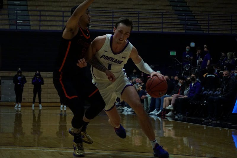 Forward Moses Wood driving to the basket in a game against Pacific University in Jan. 