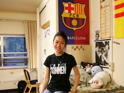  Junior Dorothea Nguyen sits in her Kenna Hall room. She finds living on campus more convenient partly because of her two campus jobs.Photo by Becca Tabor.